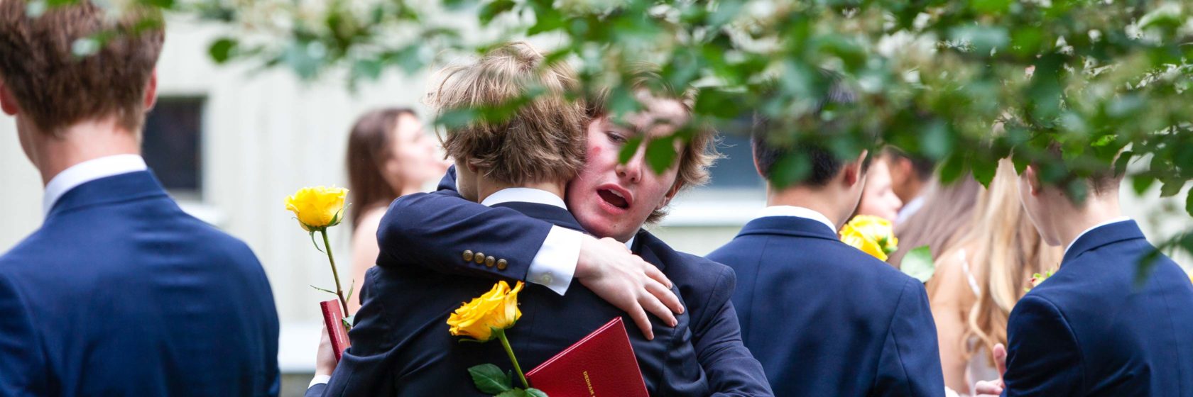 Students hugging during graduation