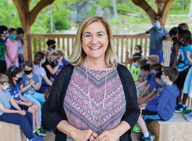 Woman with children in background in outdoor classroom