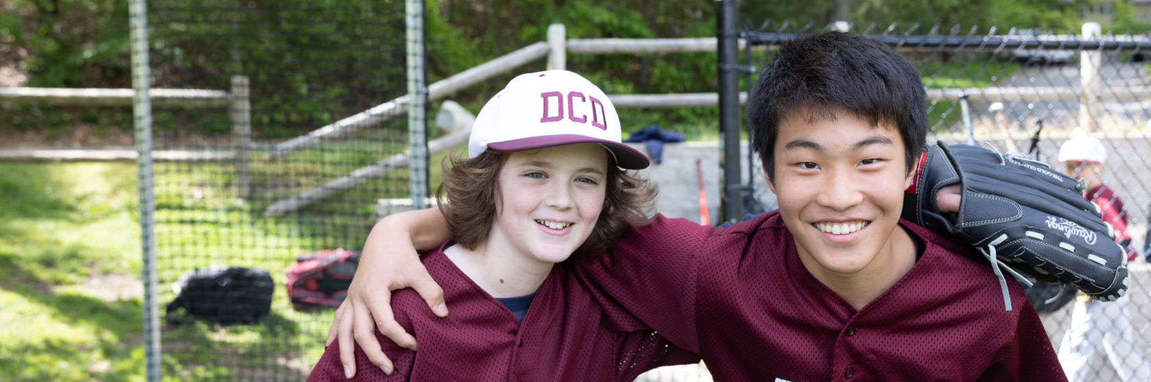 Two baseball players take a break from the game.