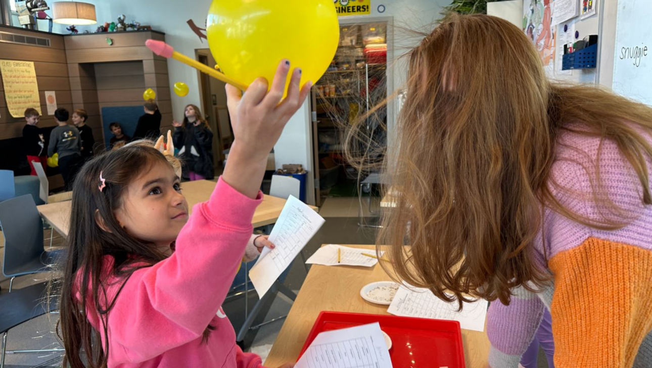 Student holding balloon creating static electricity